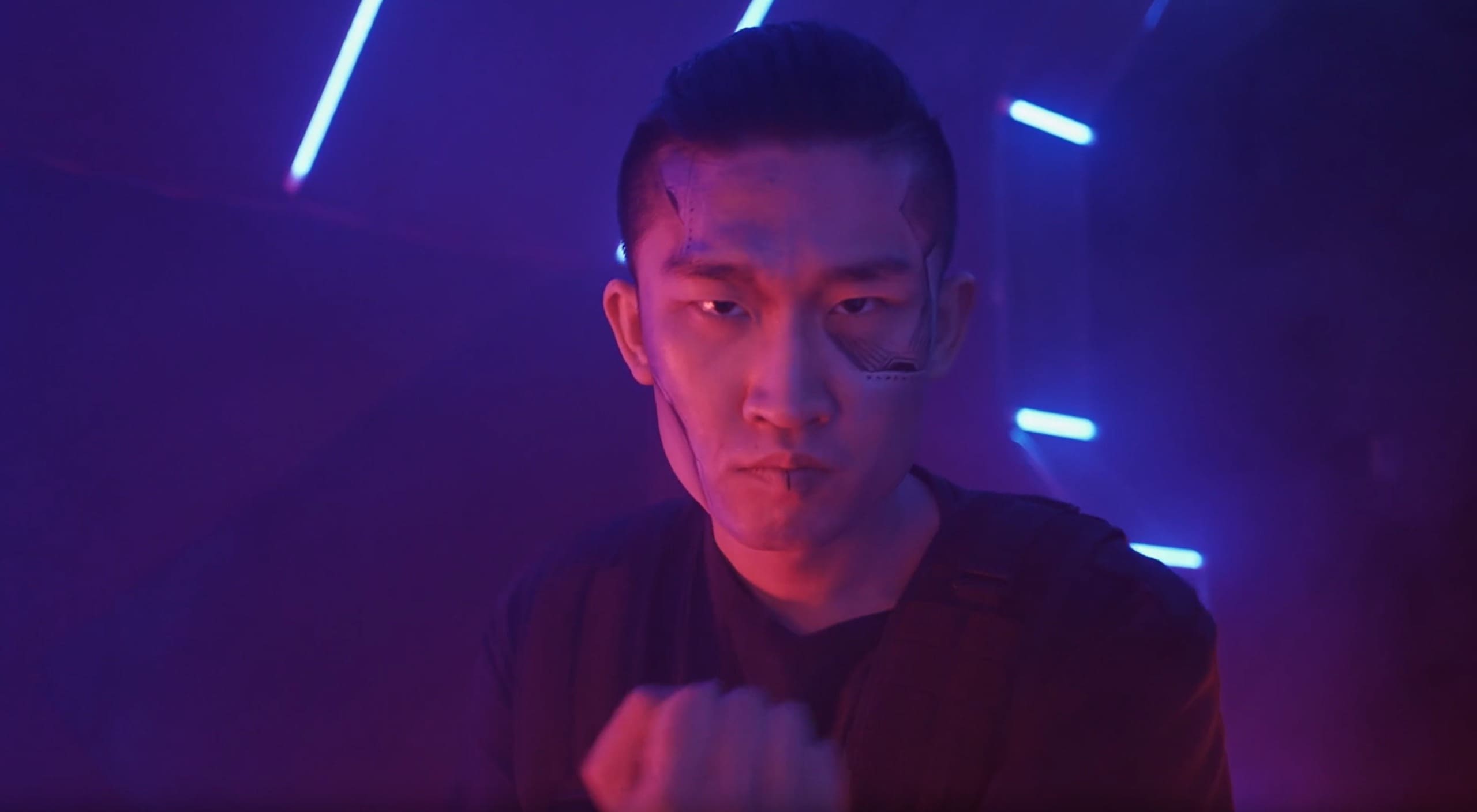 Portrait lit in blue and violet neon, fist raised